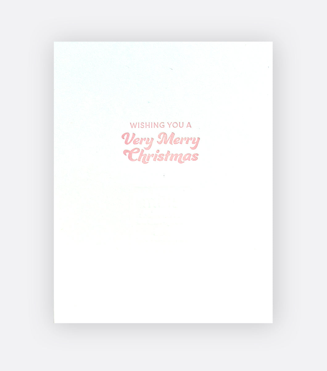 Inside of a holiday card that says "wishing you a very merry christmas"